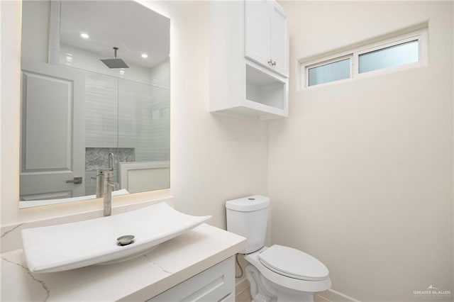 bathroom with toilet, a shower stall, recessed lighting, and vanity