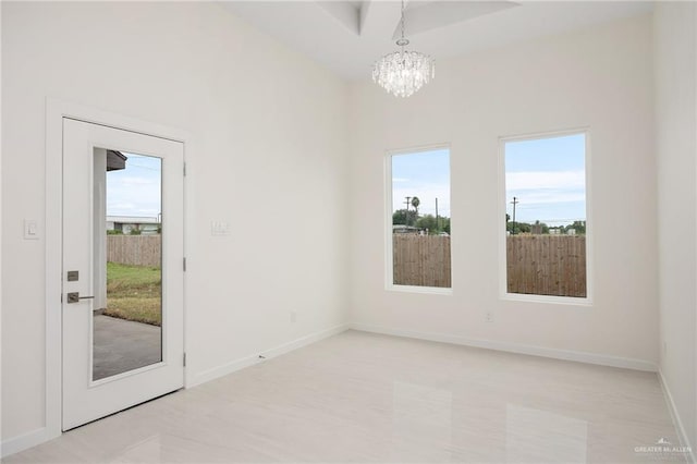 interior space with baseboards and a chandelier