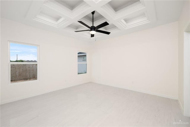 unfurnished room with ceiling fan, baseboards, coffered ceiling, and beamed ceiling