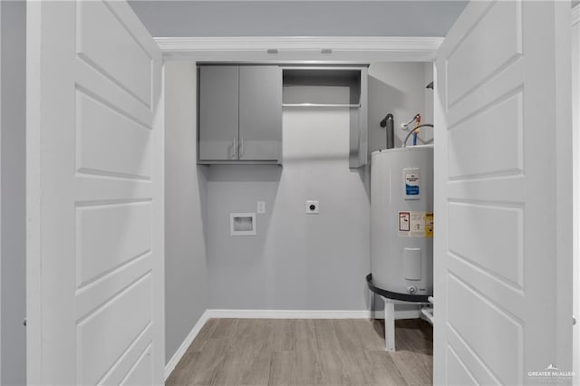 207 W Campeche Ave, Alton, TX 78573 - laundry room with electric water heater, hookup for an electric dryer, cabinet space, light wood-style floors, and washer hookup