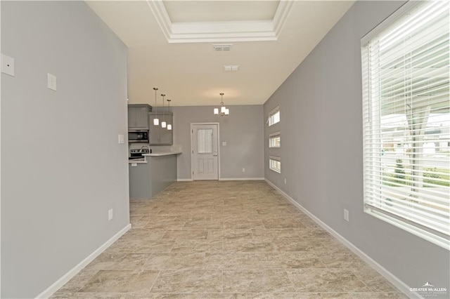 207 W Campeche Ave, Alton, TX 78573 - unfurnished living room with plenty of natural light, a raised ceiling, and a chandelier