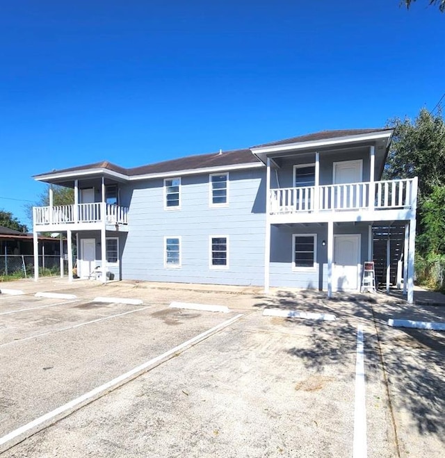 view of front of home featuring a balcony