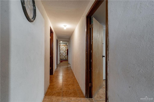 21707 Hidalgo St, Edcouch, TX 78538 - hallway with light tile patterned flooring and a textured wall