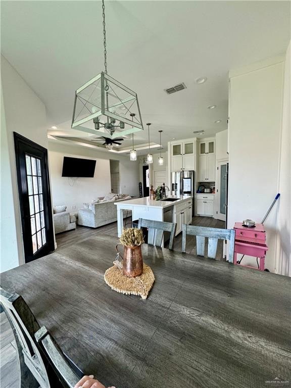 dining room featuring ceiling fan and sink