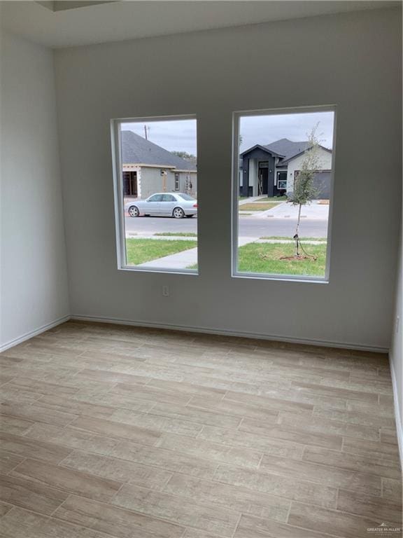 unfurnished room featuring light wood-type flooring