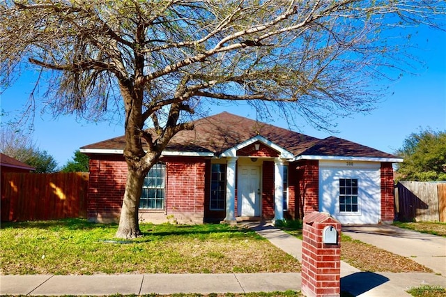 ranch-style house featuring a garage and a front yard