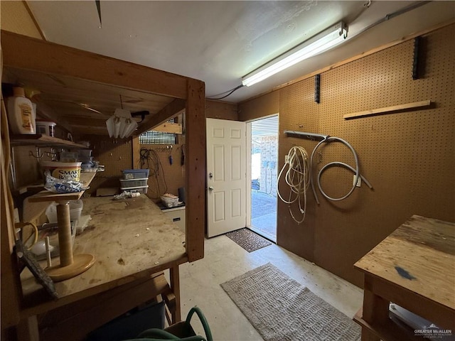 entrance foyer featuring concrete floors and a workshop area