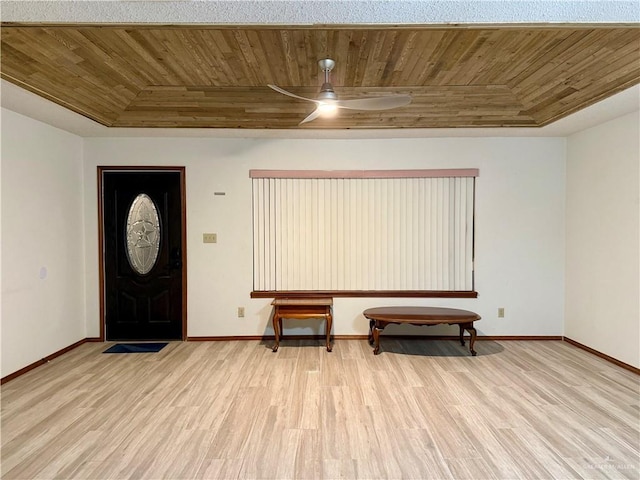 entrance foyer featuring baseboards, a raised ceiling, wood ceiling, and light wood-style floors