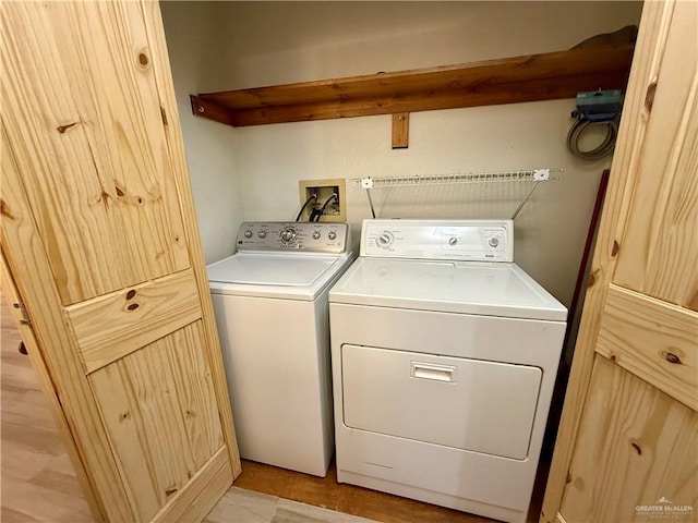 washroom featuring laundry area and separate washer and dryer