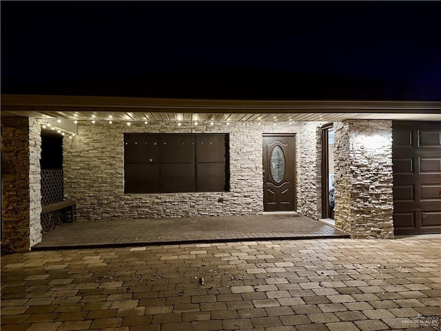 exterior entry at night with a garage