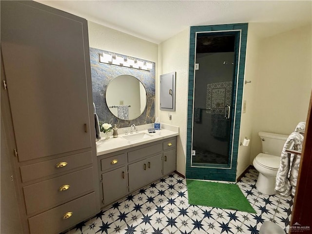 full bathroom featuring a stall shower, vanity, toilet, and tile patterned floors