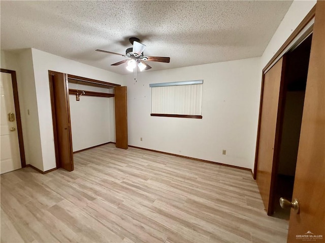 unfurnished bedroom with light wood-type flooring, a textured ceiling, and a closet