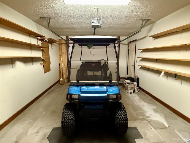 garage with baseboards and a garage door opener