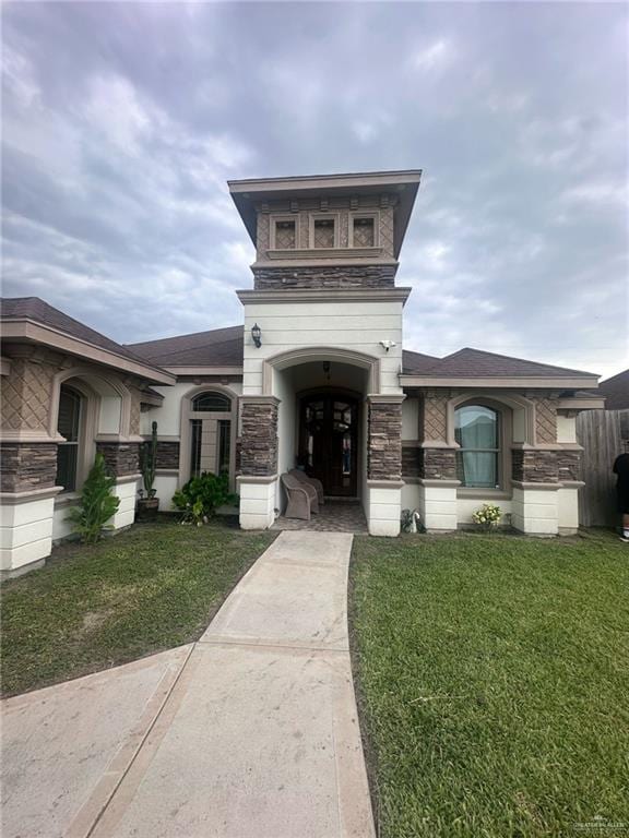 2308 Monte Grande Dr, San Juan, TX 78589 - view of front of house featuring stone siding and a front lawn