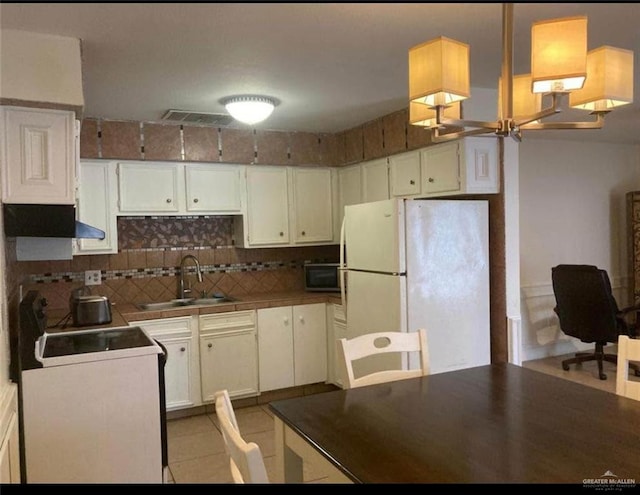 817 Toronto Ave Unit 7, Mcallen, TX 78501 - kitchen with white cabinets, tasteful backsplash, a sink, and white appliances