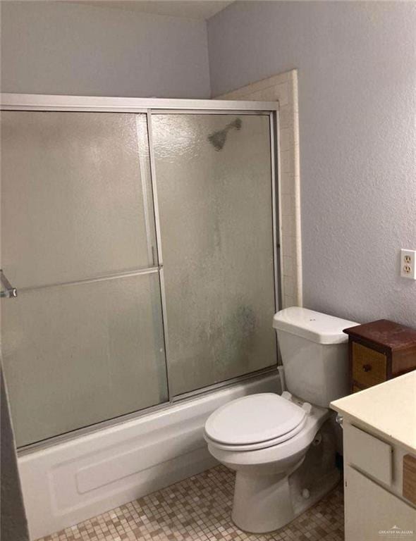 817 Toronto Ave Unit 7, Mcallen, TX 78501 - full bath with toilet, a textured wall, vanity, and combined bath / shower with glass door