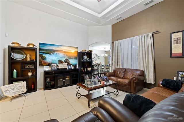 living room featuring a notable chandelier and light tile patterned floors