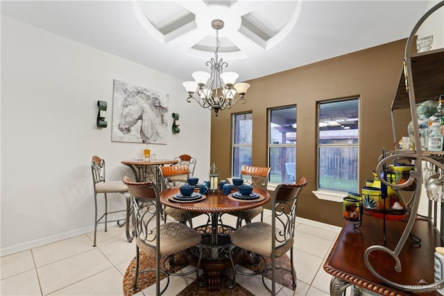 tiled dining area featuring coffered ceiling and a notable chandelier