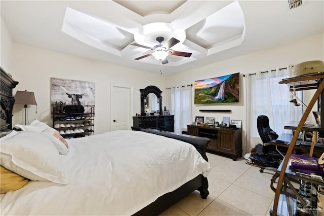 tiled bedroom with coffered ceiling and ceiling fan