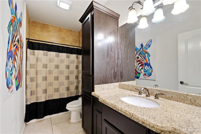 bathroom with vanity, tile patterned floors, toilet, and walk in shower