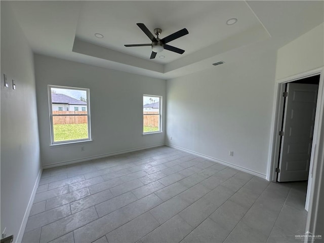 408 Janet Cir N, La Feria, TX 78559 - empty room with a tray ceiling and a ceiling fan