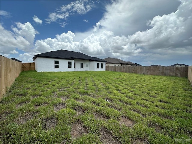408 Janet Cir N, La Feria, TX 78559 - rear view of property featuring a fenced backyard