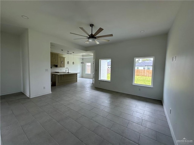 408 Janet Cir N, La Feria, TX 78559 - unfurnished living room with ceiling fan, tile patterned floors, and recessed lighting