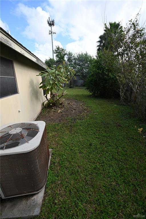 view of yard with central AC