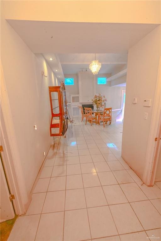 hall featuring an inviting chandelier and light tile patterned flooring