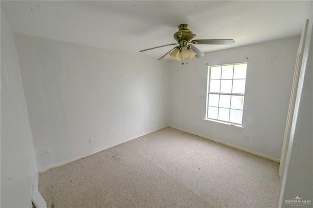 unfurnished room with ceiling fan and light colored carpet