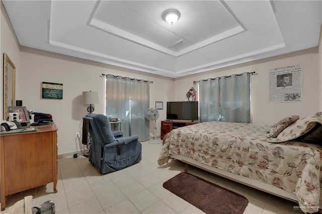 bedroom featuring a tray ceiling and light tile patterned flooring