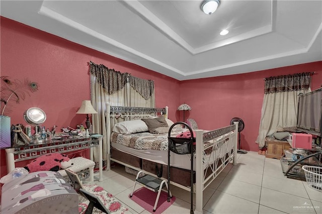 tiled bedroom with a tray ceiling