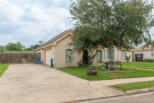 view of front of house featuring an attached garage, driveway, and stone siding