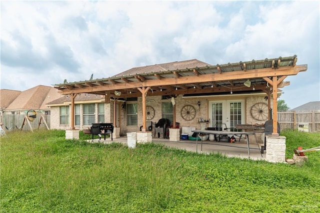 back of house featuring french doors, a patio, fence, a pergola, and brick siding