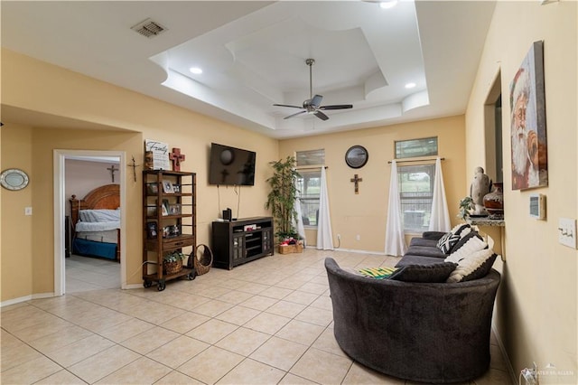 living area featuring ceiling fan, a raised ceiling, light tile patterned flooring, baseboards, and recessed lighting