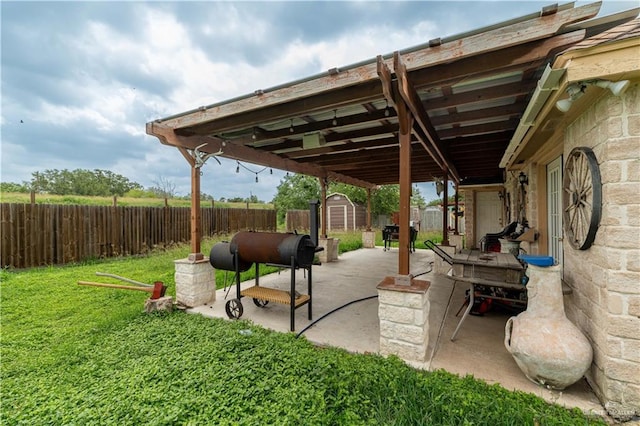 view of patio / terrace featuring a storage shed and an outbuilding