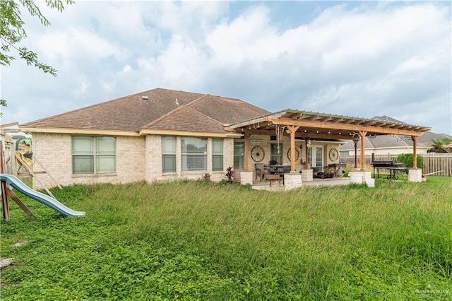 back of house featuring a pergola, fence, a patio, a playground, and a shingled roof