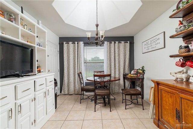 dining area featuring a chandelier and light tile patterned flooring
