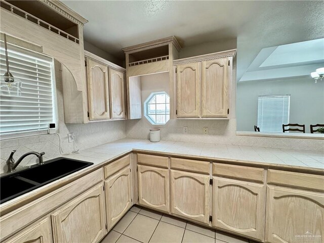 4208 Country St, Edinburg, TX 78541 - kitchen with light brown cabinetry, a sink, tile counters, decorative backsplash, and light tile patterned flooring