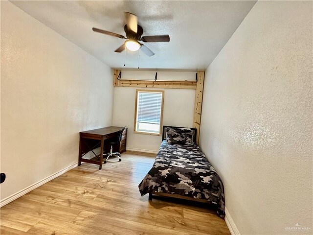 4208 Country St, Edinburg, TX 78541 - bedroom featuring wood finished floors, baseboards, a textured wall, and a ceiling fan