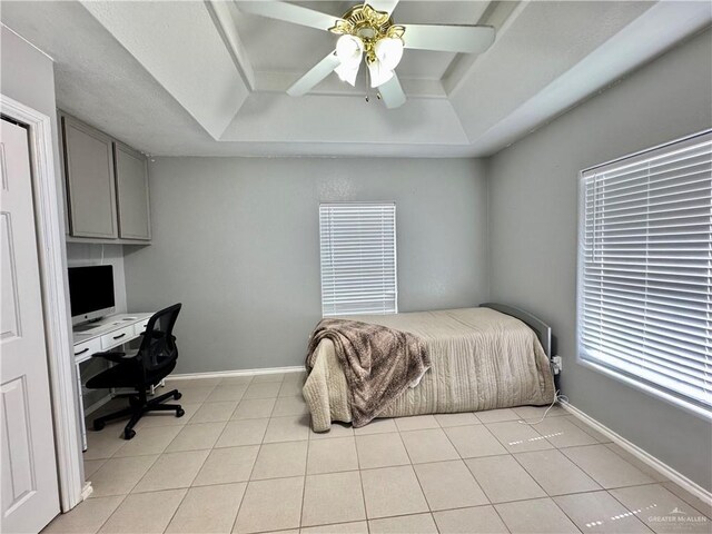 4208 Country St, Edinburg, TX 78541 - bedroom featuring a tray ceiling, an office area, light tile patterned floors, and baseboards