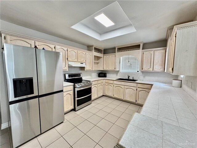 4208 Country St, Edinburg, TX 78541 - kitchen with appliances with stainless steel finishes, under cabinet range hood, light tile patterned floors, a sink, and light brown cabinetry