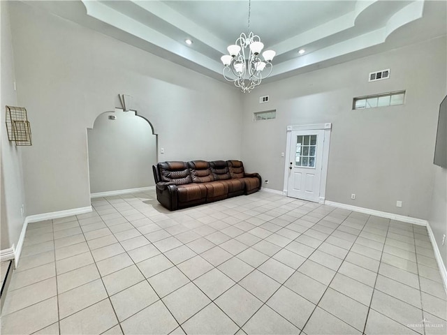 4208 Country St, Edinburg, TX 78541 - sitting room with a high ceiling, a chandelier, a tray ceiling, baseboards, and light tile patterned floors