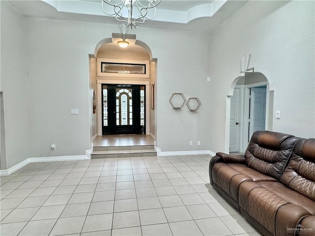 4208 Country St, Edinburg, TX 78541 - entryway with light tile patterned floors, a tray ceiling, arched walkways, and a towering ceiling