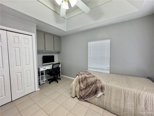 4208 Country St, Edinburg, TX 78541 - bedroom with light tile patterned floors, an office area, a raised ceiling, a closet, and ceiling fan