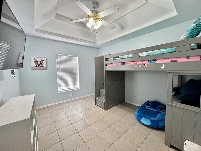 4208 Country St, Edinburg, TX 78541 - bedroom with a raised ceiling, light tile patterned floors, a ceiling fan, and baseboards