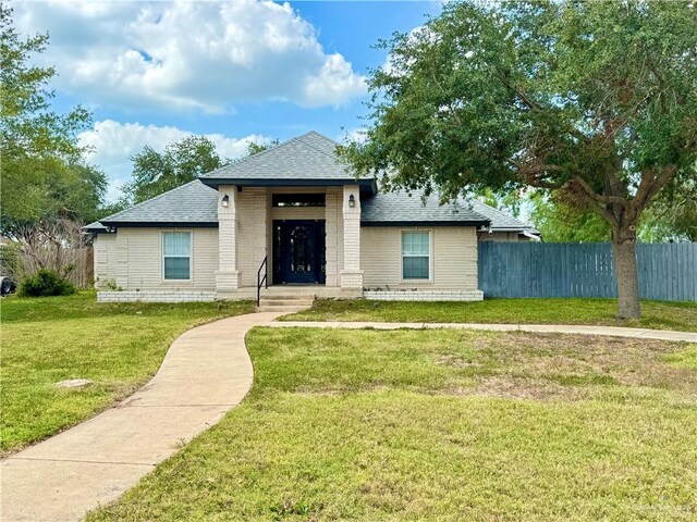 4208 Country St, Edinburg, TX 78541 - view of front of house featuring roof with shingles and brick siding