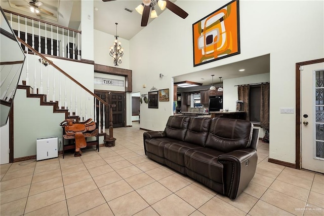 living room with ceiling fan, high vaulted ceiling, and light tile patterned floors