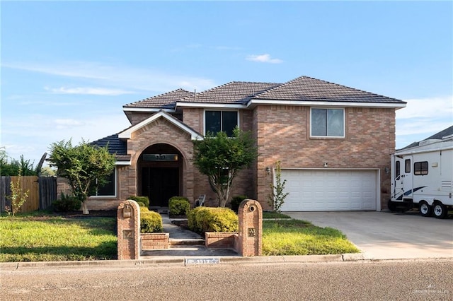 view of property featuring a front yard and a garage