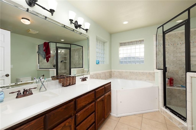 full bathroom featuring tile patterned flooring, shower with separate bathtub, vanity, and toilet